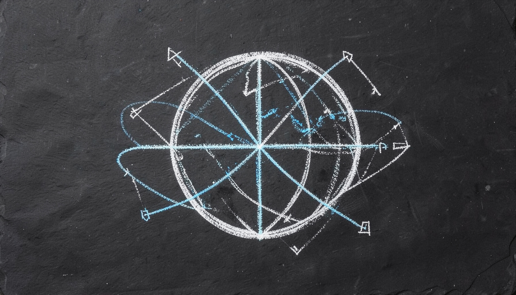 A chalk drawing on a dark slate board showing a globe with intersecting orbital paths and geometric survey markers